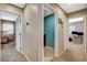 Hallway featuring doors leading to rooms with carpeted and tiled flooring, allowing for easy transitions at 9931 Cherry Melee Ave, Las Vegas, NV 89148