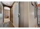 Hallway view with a barn door entry to a bathroom featuring a glass shower at 9931 Cherry Melee Ave, Las Vegas, NV 89148