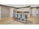 Well-lit kitchen featuring a functional island with bar seating, complemented by stainless steel appliances at 9931 Cherry Melee Ave, Las Vegas, NV 89148