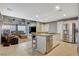 Open-concept kitchen with granite countertops, stainless steel appliances, and a view into the cozy living room at 9931 Cherry Melee Ave, Las Vegas, NV 89148