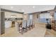 Bright kitchen featuring an island with bar seating, granite countertops, and stainless steel appliances at 9931 Cherry Melee Ave, Las Vegas, NV 89148