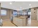 Open kitchen with island, granite countertops, stainless dishwasher, and tile floors at 9931 Cherry Melee Ave, Las Vegas, NV 89148