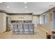 Bright kitchen featuring an island with bar seating, granite countertops, and stainless steel appliances at 9931 Cherry Melee Ave, Las Vegas, NV 89148