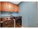 Efficient laundry room boasts modern appliances and cabinets, combining practicality and style at 9931 Cherry Melee Ave, Las Vegas, NV 89148