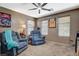Living room area featuring two comfortable looking recliners, each with their own side table and lots of natural light at 9931 Cherry Melee Ave, Las Vegas, NV 89148