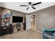 Living room with a large TV, a set of speakers and a door leading into another area at 9931 Cherry Melee Ave, Las Vegas, NV 89148