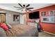 Cozy bedroom features a ceiling fan, dresser, and a large screen television, creating a relaxing retreat at 9931 Cherry Melee Ave, Las Vegas, NV 89148