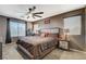 Comfortable main bedroom suite featuring a large bed, natural light and a ceiling fan at 9931 Cherry Melee Ave, Las Vegas, NV 89148