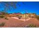 A large backyard has lounge chairs, a fire pit, string lights, and mountain views at 10149 Terrastone Dr, Las Vegas, NV 89148