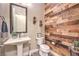 Rustic powder room with wood accent wall and modern fixtures at 10149 Terrastone Dr, Las Vegas, NV 89148