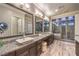 Spacious bathroom with granite counters, dual sinks, soaking tub, and glass shower at 10149 Terrastone Dr, Las Vegas, NV 89148