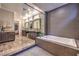 Bathroom boasts a soaking tub, separate shower, dual sinks, and modern tile at 10149 Terrastone Dr, Las Vegas, NV 89148