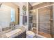 Beautiful bathroom with wood tile walls and granite counter and stand up shower at 10149 Terrastone Dr, Las Vegas, NV 89148