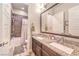 Bathroom showcasing a double vanity, granite counters, and tiled shower at 10149 Terrastone Dr, Las Vegas, NV 89148