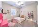 Stylish bedroom with bright pink desk and chair, and decorative mirror at 10149 Terrastone Dr, Las Vegas, NV 89148