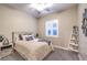 Cozy bedroom featuring a bed, shutters, ceiling fan, and decorative ladder at 10149 Terrastone Dr, Las Vegas, NV 89148