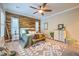 Beautiful bedroom with wood accent wall, ceiling fan, patterned rug, and neutral color palette at 10149 Terrastone Dr, Las Vegas, NV 89148