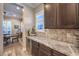Butlers pantry with granite counters, upper cabinets and wine refrigerator at 10149 Terrastone Dr, Las Vegas, NV 89148