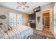 This bedroom has a wet bar, tv, and a beautiful bathroom with stand up shower, all accented by wood flooring at 10149 Terrastone Dr, Las Vegas, NV 89148