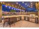 An outdoor kitchen features granite counters and stainless steel grill and accents at 10149 Terrastone Dr, Las Vegas, NV 89148