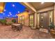 The outdoor patio includes brick pavers and a dining table for entertaining at 10149 Terrastone Dr, Las Vegas, NV 89148