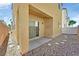 Cozy backyard with low maintenance landscaping, a concrete patio, and sliding door access to the house at 10162 Sunshine Village Pl, Las Vegas, NV 89183