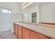 Primary bathroom featuring double sinks, large mirror, and separate tub at 10162 Sunshine Village Pl, Las Vegas, NV 89183