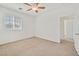 Bright bedroom with neutral carpet, a ceiling fan, and natural light at 10162 Sunshine Village Pl, Las Vegas, NV 89183