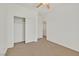 Bedroom with a ceiling fan, a closet, and a neutral colored carpet at 10162 Sunshine Village Pl, Las Vegas, NV 89183