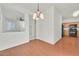Bright dining room with hardwood floors, chandelier, and view into the kitchen at 10162 Sunshine Village Pl, Las Vegas, NV 89183
