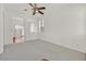 Bright living room with neutral carpet, ceiling fan, and bright white walls creating an airy and open feel at 10162 Sunshine Village Pl, Las Vegas, NV 89183