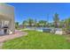 Spacious backyard featuring a pristine lawn, a fenced pool area, and a spa, ideal for entertaining at 1035 Tabor Hill Ave, Henderson, NV 89074
