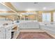Bright bathroom with dual sinks, vanity, large mirror, and soaking tub at 1035 Tabor Hill Ave, Henderson, NV 89074