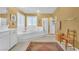 Bright bathroom featuring a garden tub, separate glass shower, and white vanity at 1035 Tabor Hill Ave, Henderson, NV 89074