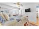 Comfortable bedroom featuring a ceiling fan, TV, and large bed with plush pillows at 1035 Tabor Hill Ave, Henderson, NV 89074