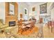 Bright dining room featuring a cozy fireplace, large dining table, and elegant decor at 1035 Tabor Hill Ave, Henderson, NV 89074