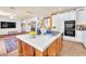 Open kitchen featuring a center island with seating, white cabinetry, and modern appliances at 1035 Tabor Hill Ave, Henderson, NV 89074