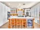 Modern kitchen with a large island, wine cooler, white cabinets, and contemporary appliances at 1035 Tabor Hill Ave, Henderson, NV 89074