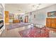 Open concept living room with tile flooring, area rugs, and french doors to backyard at 1035 Tabor Hill Ave, Henderson, NV 89074