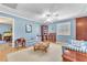 Bright living room with pale blue walls, hardwood floors, and comfortable seating at 1035 Tabor Hill Ave, Henderson, NV 89074
