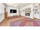Comfortable living room with a mounted television and tile flooring with area rugs at 1035 Tabor Hill Ave, Henderson, NV 89074