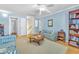 Bright living room with pale blue walls, hardwood floors, and comfortable seating with stairs in view at 1035 Tabor Hill Ave, Henderson, NV 89074