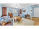 Bright living room with pale blue walls, hardwood floors, and comfortable seating with large window shutters at 1035 Tabor Hill Ave, Henderson, NV 89074
