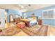 Bright main bedroom with pale blue walls, hardwood floors, and large antique rug at 1035 Tabor Hill Ave, Henderson, NV 89074