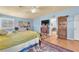 Bright main bedroom with pale blue walls and hardwood floors that connect to another room at 1035 Tabor Hill Ave, Henderson, NV 89074