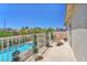 Enjoy outdoor dining with a view from this balcony overlooking the sparkling pool at 1035 Tabor Hill Ave, Henderson, NV 89074