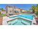 Beautiful backyard featuring a pool, jacuzzi, lush landscaping, and a patio with seating at 1035 Tabor Hill Ave, Henderson, NV 89074