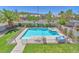 Aerial view of a private pool and spa surrounded by lush landscaping and a safety fence at 1035 Tabor Hill Ave, Henderson, NV 89074