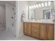 Bright bathroom with a double sink vanity with modern fixtures, wood cabinets and a shower-tub combination at 1050 Bruce St, Pahrump, NV 89048
