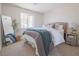 Cozy bedroom featuring neutral carpet, a decorative mirror, and a bright window at 1050 Bruce St, Pahrump, NV 89048